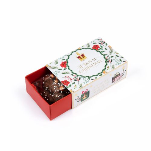 matchbox packaging of three chocolate wreaths including illustrations of flowers and foliage and presents on the outside including gold foil stars