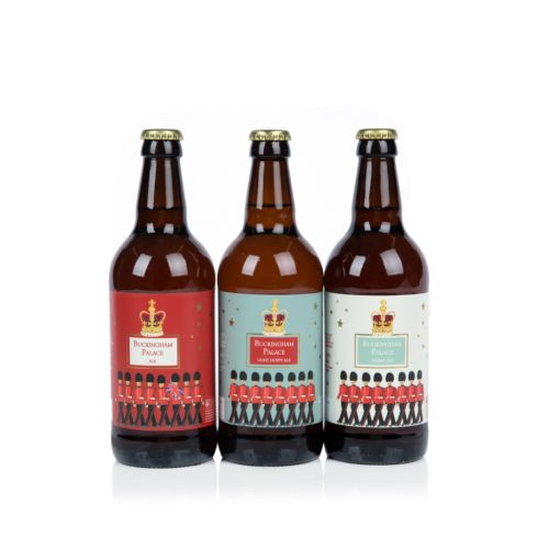 three beer bottles decorated with guardsman and crowns