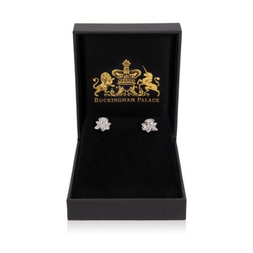 two silver stud earrings in the shape of daffodils