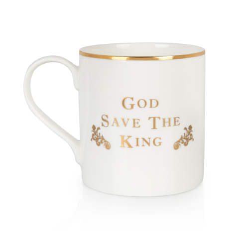 A white mug with royal crest, and handle with flowers in the background, biscuits in the foreground  and the rest of the Coat of Arms china selection. 