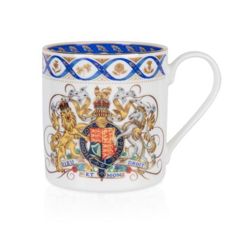 White coffee mug with Royal coat of arms, blue ribbon and national flowers in gold round the rim.