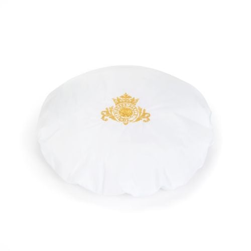 White shower cap with gold embroidered crest. 