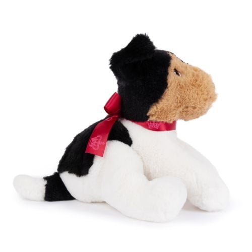 dog soft toy with brown soft face and black ears. Red satin bow with details of crowns