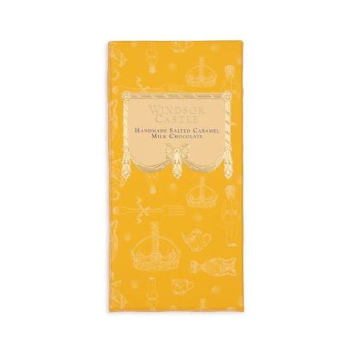 Bar of chocolate next to yellow packaging sleeve. Illustrated with items from the Royal Collection