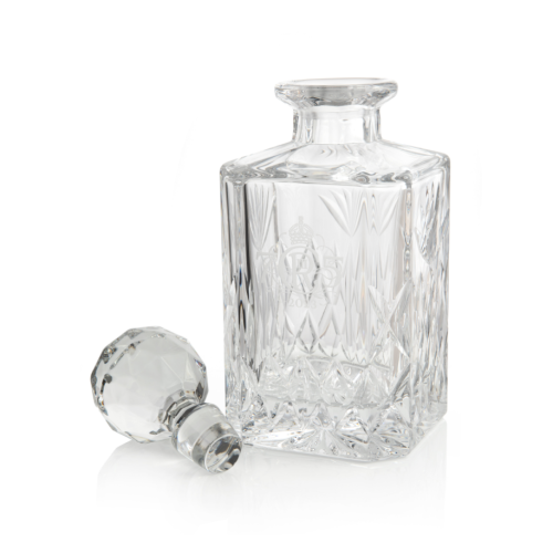 glass decanter with round glass bottle stop and decorative etching of cypher on the front