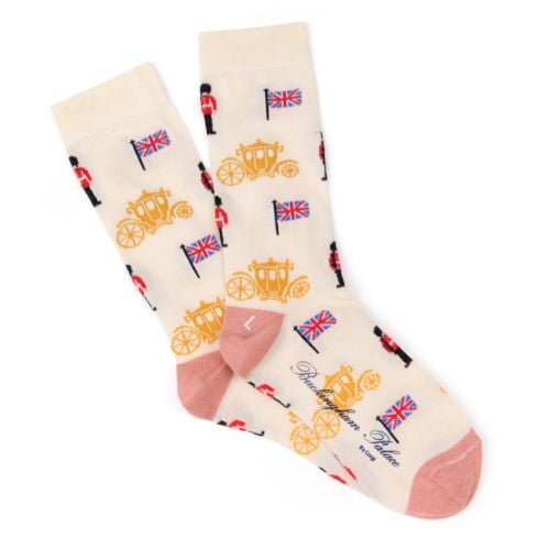 Cream pair of socks with light pink heels and toes. Gold carriage, Guardsman and Union Jack print. 