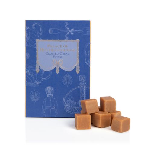 Front of Palace of Holyroodhosue clotted cream fudge box. A pile of clotted cream fudge to the right. 