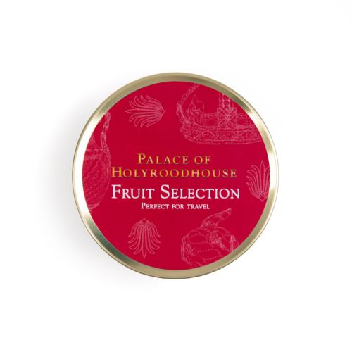 Top of tin of fruit selection. Red background on gold round tin with white illustrations featuring a variety of illustrations including teacup, fork and crown. 