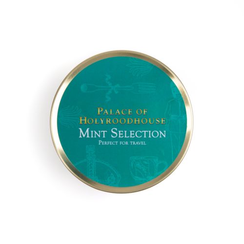 Top of tin of mint selection. Turquoise background on gold round tin with white illustrations featuring a variety of illustrations including teacup, fork and crown. 
