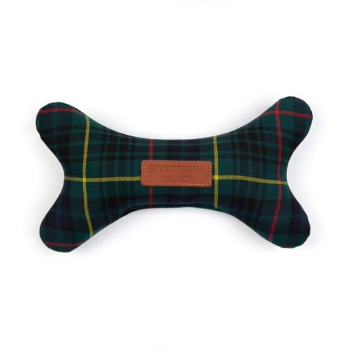 stuffed bone toy in a tartan fabric with a small rectangle leather label that reads BUCKINGHAM PALACE.
