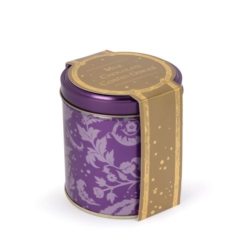 Purple tin with acanthus print and pile of ginger coated in chocolate.