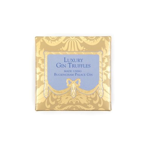 A golden chocolate box with blue writing and centre, stating "Luxury Gin Truffles, made using Buckingham Palace Gin."