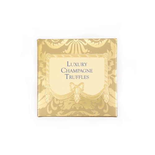 A golden patterned box with light yellow centre, featuring "Luxury Champagne Truffles" written in centre in blue text. 