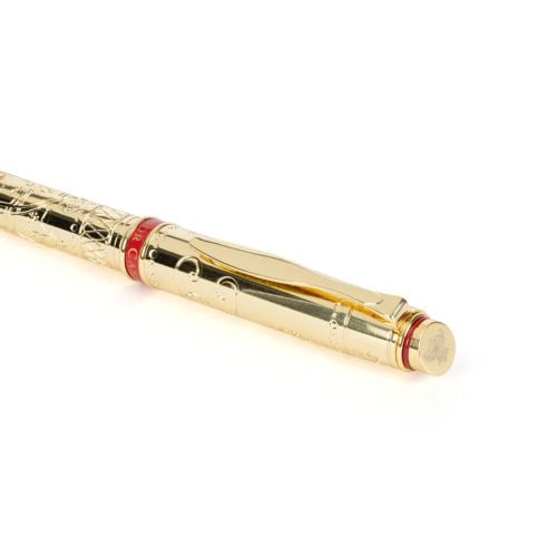 Gold ballpoiint pen with engraving and red band with Windsor Castle at centre. 
