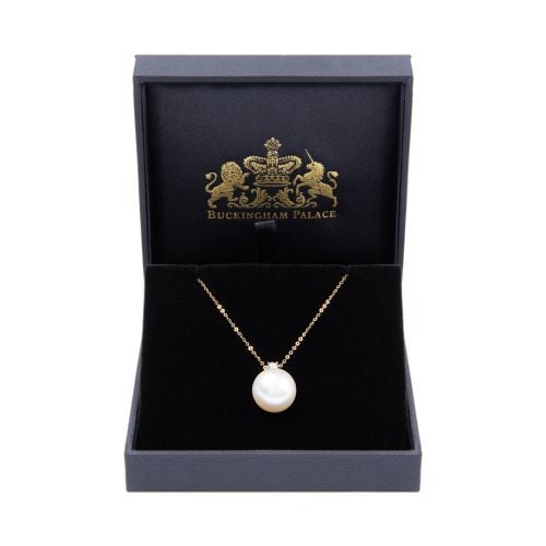 Delicate gold chain with small diamond connected to large South Sea pearl. 