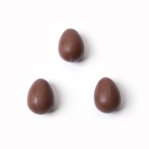 Birdcage inspired East Wing Chocolate Caramel Eggs with chocolate eggs to side. 