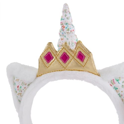 White unicorn with crown headband, woodland design detail.