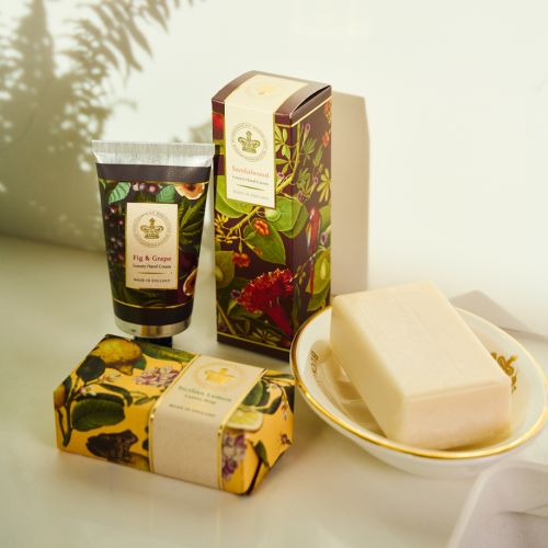 Sandalwood hand cream with a floral image on burgundy background, shown in tube and matching box.