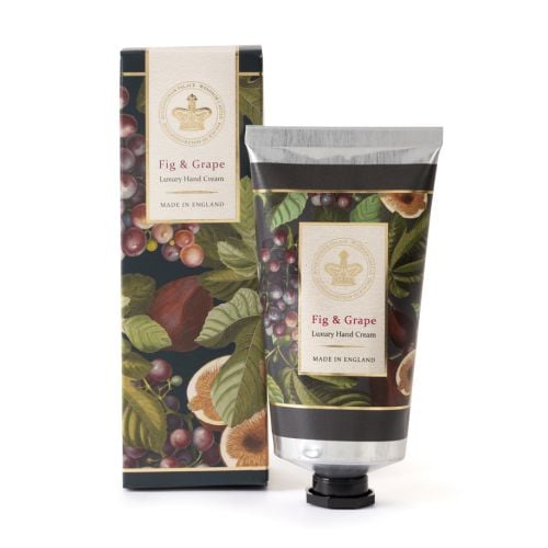 Fig and grape hand cream shown in aluminium tube and matching box, decorated with a dark background showing historical images of figs and grapes.
