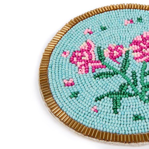 Two beaded coasters, one with a blue butterfly and one with flowers. 