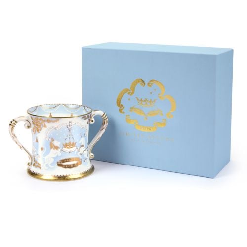 2013 limted edition number one Loving Cup featuring a lion and unicorn with gold detailing adjacent to a blue box with "Welcome to our Royal Baby" embossed in gold. 