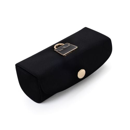 Launer lipstick case in black with Launer bag on top. 