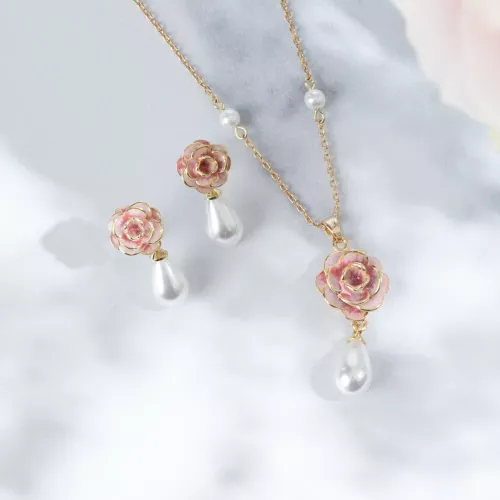 Pink rose and pearl drop pendant on gold plated chain.