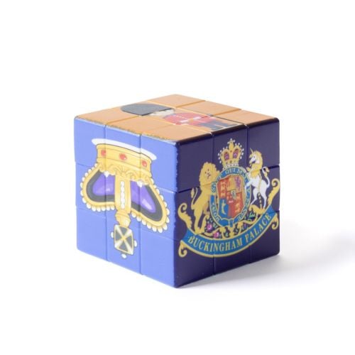 Colourful puzzle cube with Union Jack, royal horse and carriage illustration on top, and a corgi design on the side.