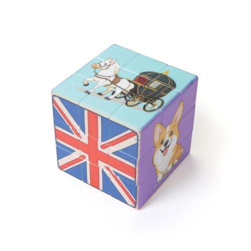 Colourful puzzle cube with Union Jack, royal horse and carriage illustration on top, and a corgi design on the side.
