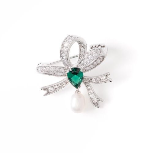 Bow crystal stud brooch with larger teardop green gem and pearl drop, set in silver.

