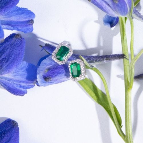 Green crystal hexagonal earrings with surrounding crystal studs, set in silver.