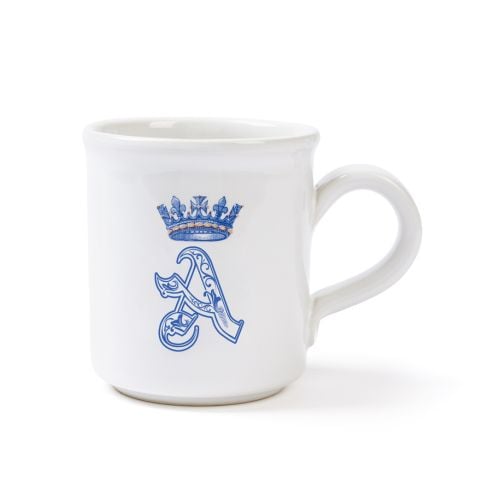 White ceramic mug featuring an ornate blue letter “A” topped with a crown design.