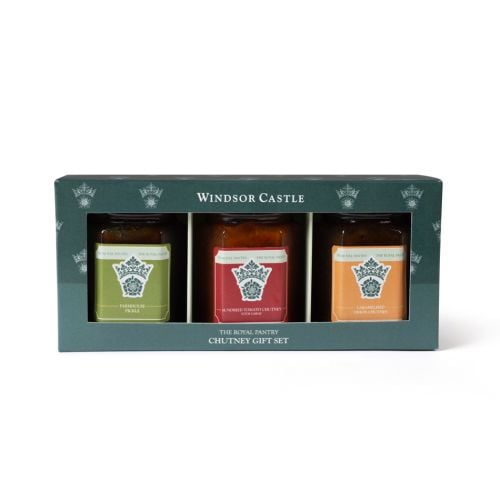 Windsor Castle Royal Pantry chutney gift set, featuring three jars—farmhouse pickle, sundried tomato and garlic chutney, and caramelised onion chutney—presented in a green gift box with crown motif.
