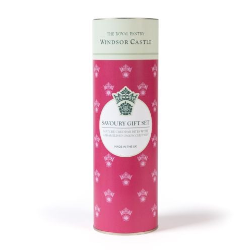 The Royal Pantry Windsor Castle savoury gift set, comprising a jar of caramelised onion chutney and mature Cheddar savoury bites, presented beside a pink cylindrical tube with crown motif.
