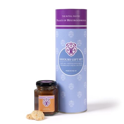 The Royal Pantry Palace of Holyroodhouse savoury gift set, comprising a jar of caramelised onion chutney and mature Cheddar savoury bites, presented in a lilac and purple cylindrical tube.
