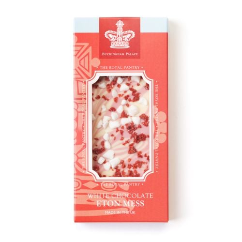Boxed bar of “White Chocolate Eton Mess” from The Royal Pantry, Buckingham Palace. The red packaging features a crown illustration and a window showing white chocolate swirled with pink strawberry, topped with white meringue pieces and red strawberry bits