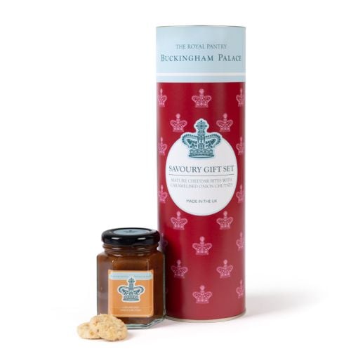 Savoury gift set featuring a tall red cylindrical tin decorated with crown motifs, accompanied by a jar of caramelised onion chutney and cheddar bites, presented against a clean background.
