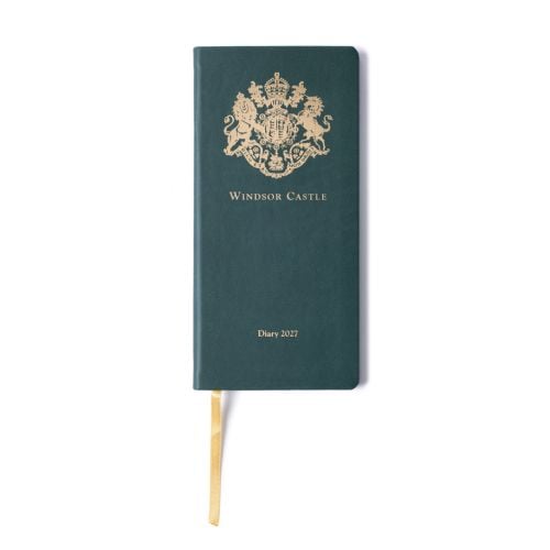 Closed Windsor Castle 2027 diary with a dark green textured cover and rounded corners. A gold royal crest is embossed at the top, with “Windsor Castle” printed beneath and “Diary 2027” near the bottom. A gold ribbon bookmark extends from the base of the d