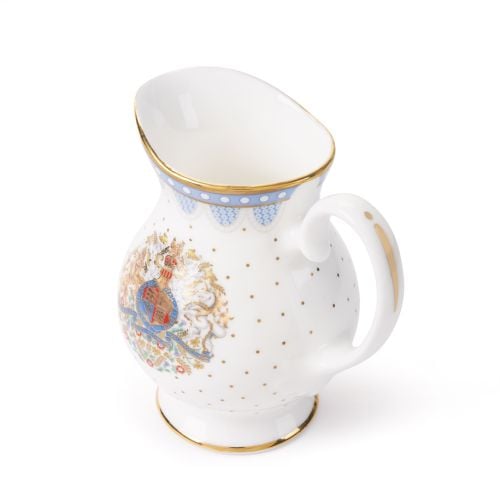 White fine bone china sugar cream jug, featuring a blue scalloped border with gold trim, gold polka dot accents, and a decorative royal-style crest on the cup, with a handle. 