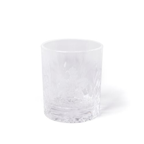 Clear cut-glass tumbler engraved with the Buckingham Palace crest, shown beside a navy box with gold crest and text.