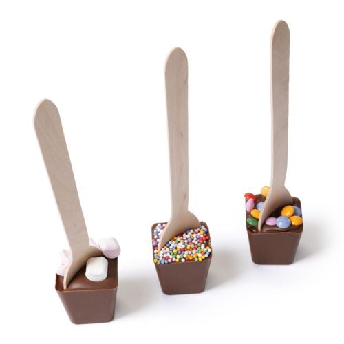Gift box of hot chocolate spoons with Union Jack bunting and Guards illustrations, showing three milk chocolate cups with wooden spoons and toppings including marshmallows, sprinkles and candy beans.