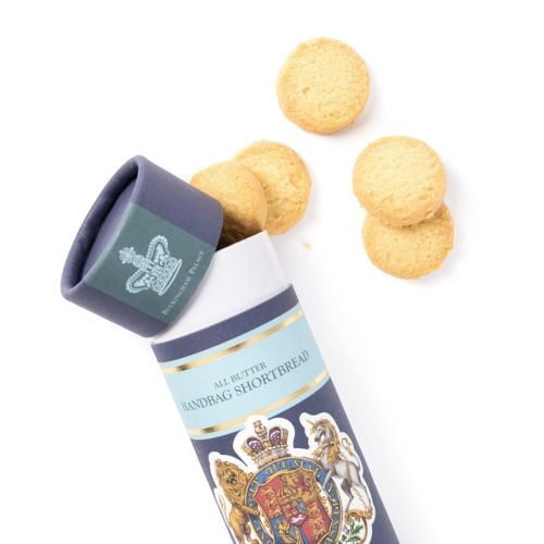 Buckingham Palace All Butter Handbag Shortbread 45g in a decorative blue and pale blue gift tube featuring a royal coat of arms, displayed with two round shortbread biscuits.