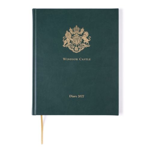 Closed Windsor Castle 2027 diary with a dark green textured cover. A gold royal crest is embossed at the top, with “Windsor Castle” printed beneath and “Diary 2027” near the bottom. A gold ribbon bookmark extends from the base.