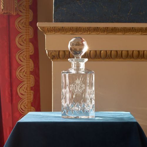 Decanter photographed with ornate background. 