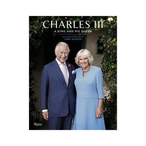 Front cover of book. Photography of Their Majesties King Charles III and Queen Camilla in front of their Highgrove home.