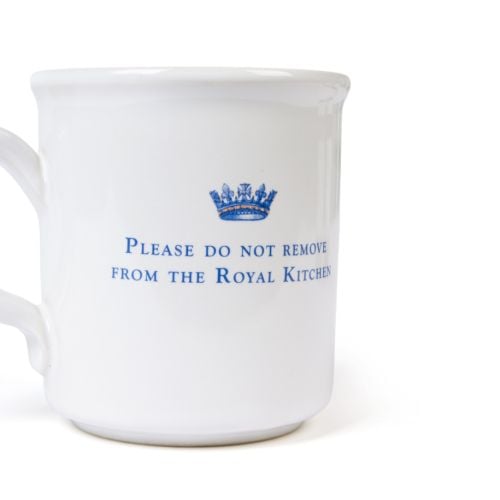 White ceramic mug featuring an ornate blue letter “A” topped with a crown design.