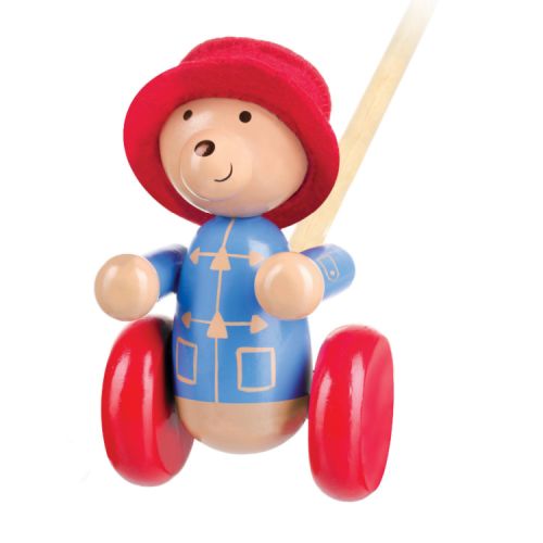 Wooden Paddington Bear toy with red farbic hat and stick to push the toy along on wheels.