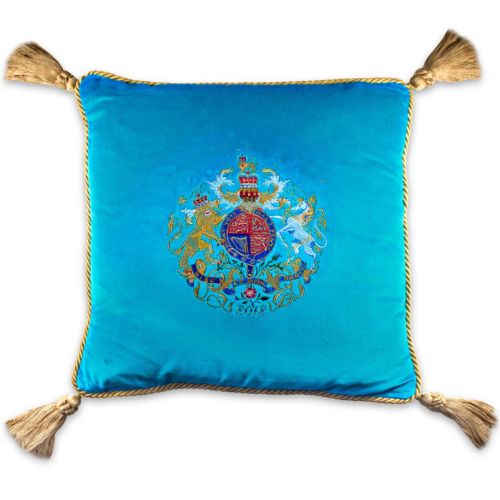Buckingham Palace blue velvet cushion featuring an embroidered royal coat of arms surmounted by the words God Save The Queen, golden rope rims and tassels in each corner. 