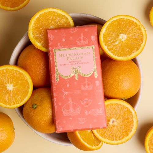 Bar of Buckingham Palace orange chocolate in orange packaging with gold detail. Illustrated with items from the Royal Collection.