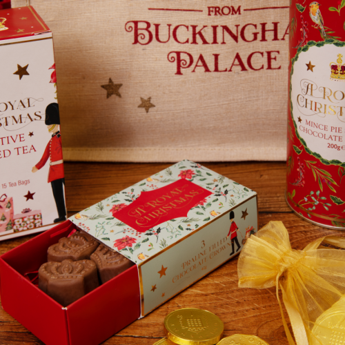 jute bag with seasons greetings from buckingham palace written on the front in red. range of the contents around the bag with presents and flowers